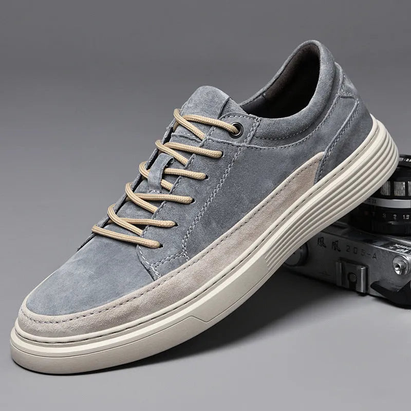 Men's grey casual leather skate shoes with a round toe and front lace-up on a soft rubber sole.