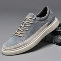 Men's grey casual leather skate shoes with a round toe and front lace-up on a soft rubber sole.