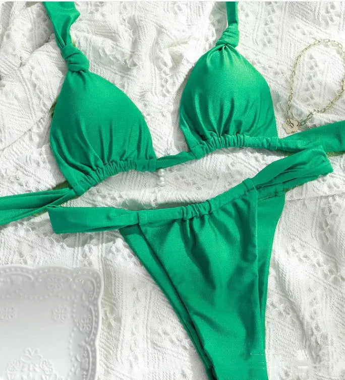 Women's pleated bikini with knotted centre and split straps in a solid colour.