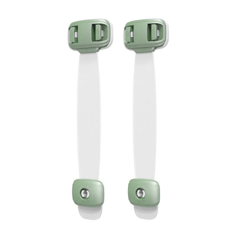 Grey and green adjustable child safety cabinet locks with adhesive backing on a kitchen drawer.