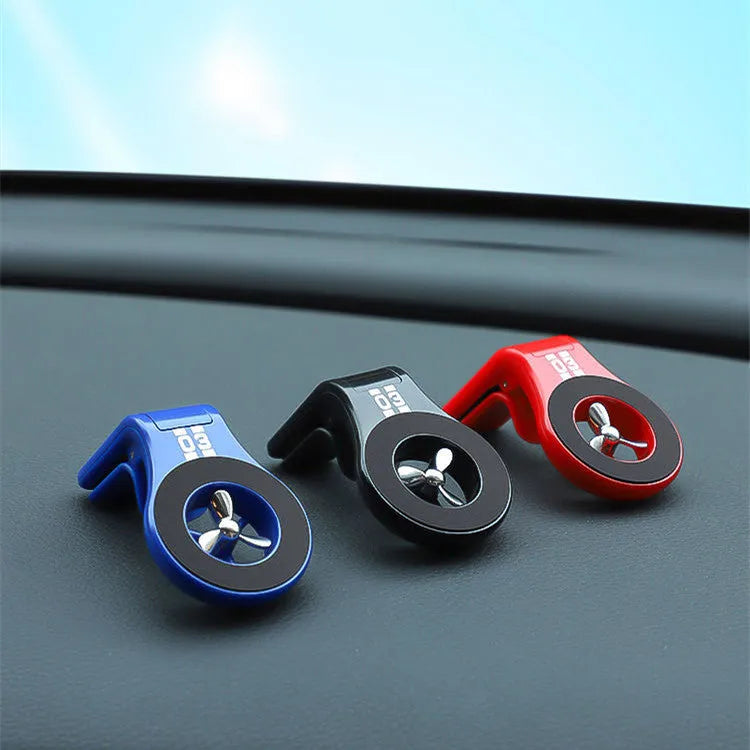 Black magnetic car phone holder mounted on vehicle air vent with smartphone attached