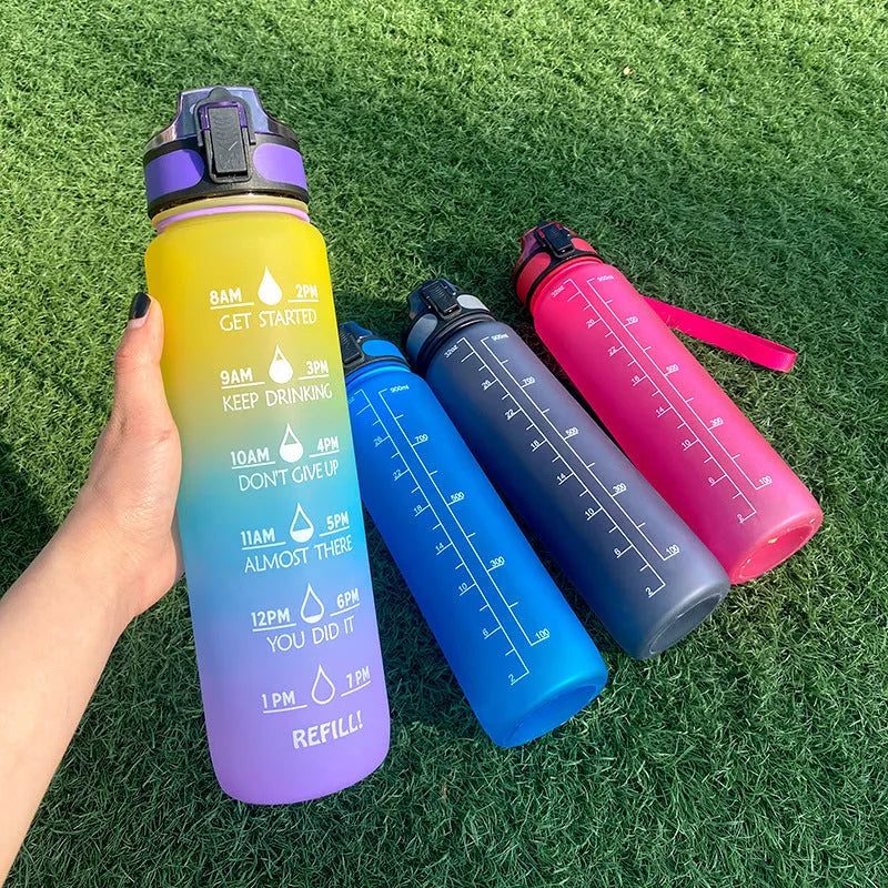 Blue and red gradient 1 litre Tritan sports water bottle with time markers and flip-top lid