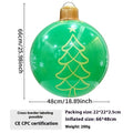 Large red inflatable Christmas ball with flash function displayed on a green garden lawn.