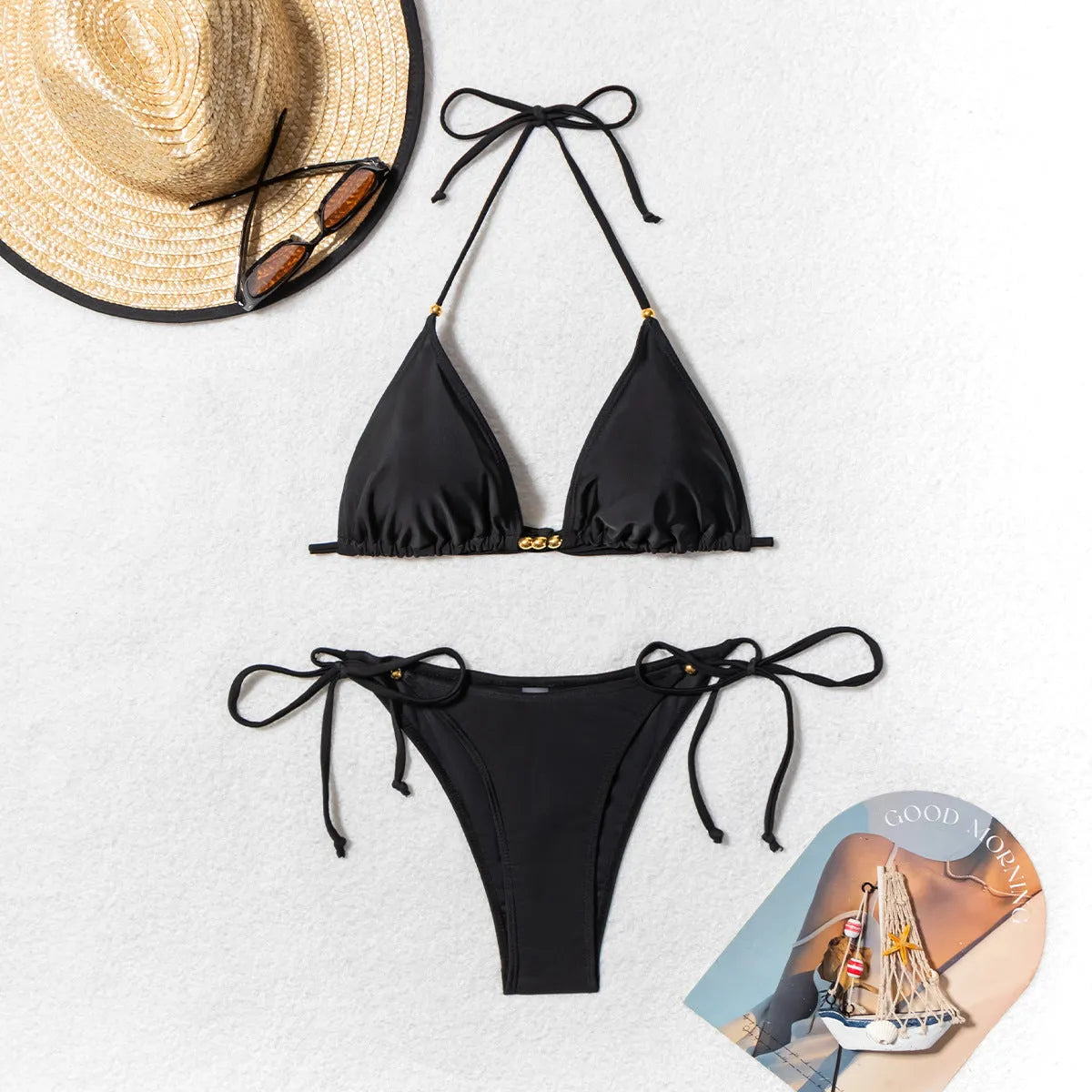 Black women's bikini swimsuit with a metal bead creating a split design on the front.