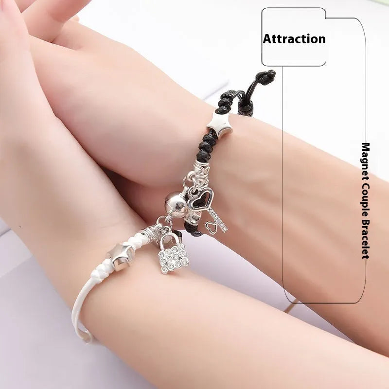 A pair of magnetic couple bracelets with alloy charms showing an I love you design and a key lock on a textured background.