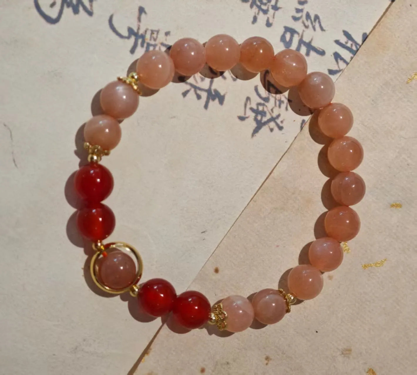 Handmade women's bracelet with 8mm red agate and sunstone beads in ethnic Xiangyun style