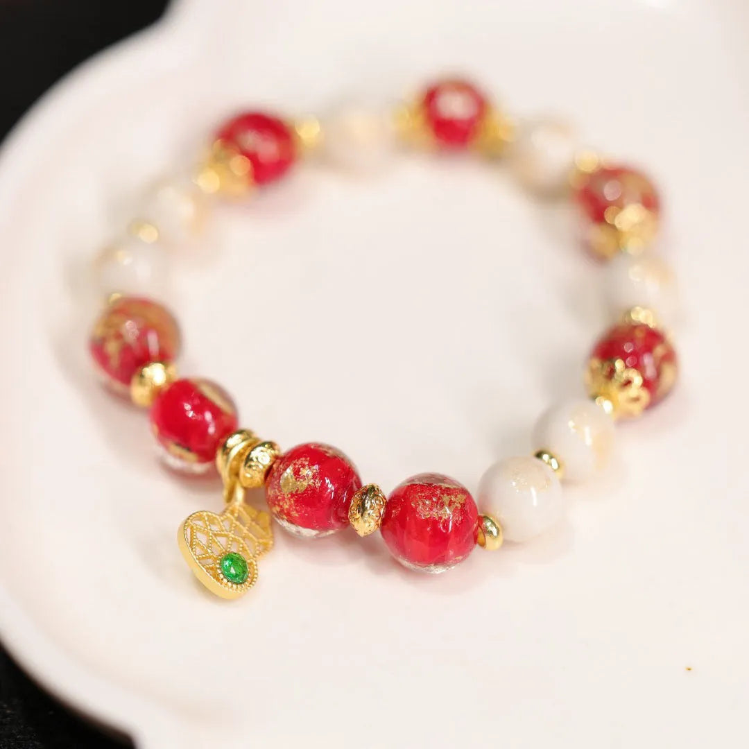 Women's ethnic bracelet with gold foil coloured glaze geometric design in pink or red colour options
