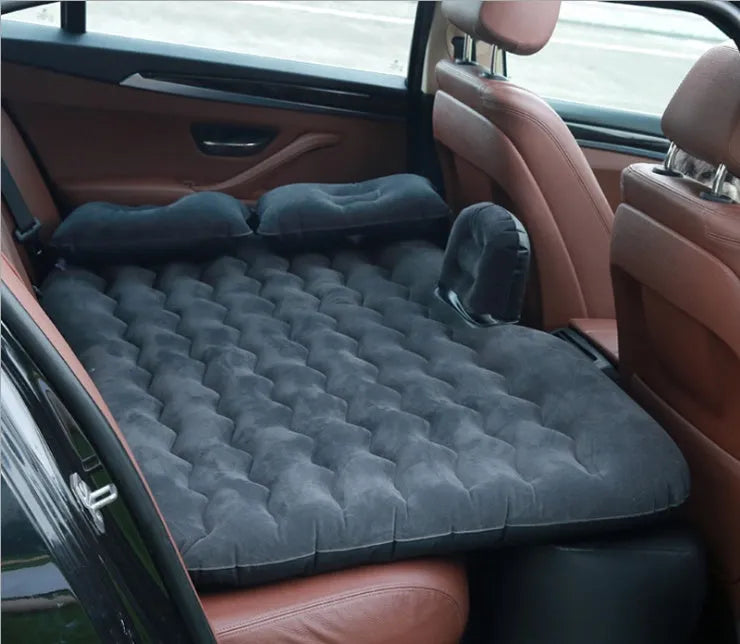 Universal inflatable car bed with flocked cloth, shown with two pillows and a pump.