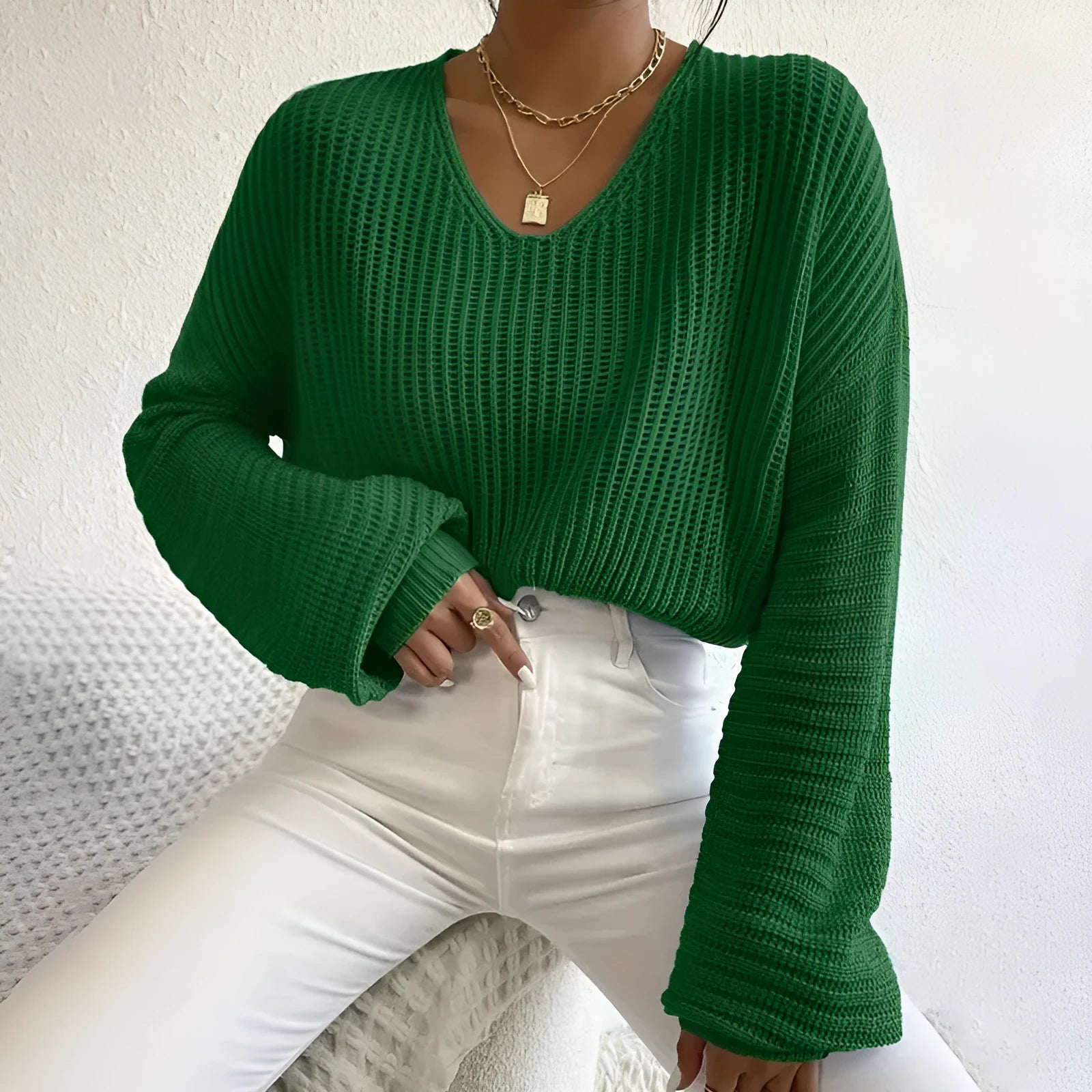 Woman wearing a solid colour long sleeve loose fit casual polyester pullover.