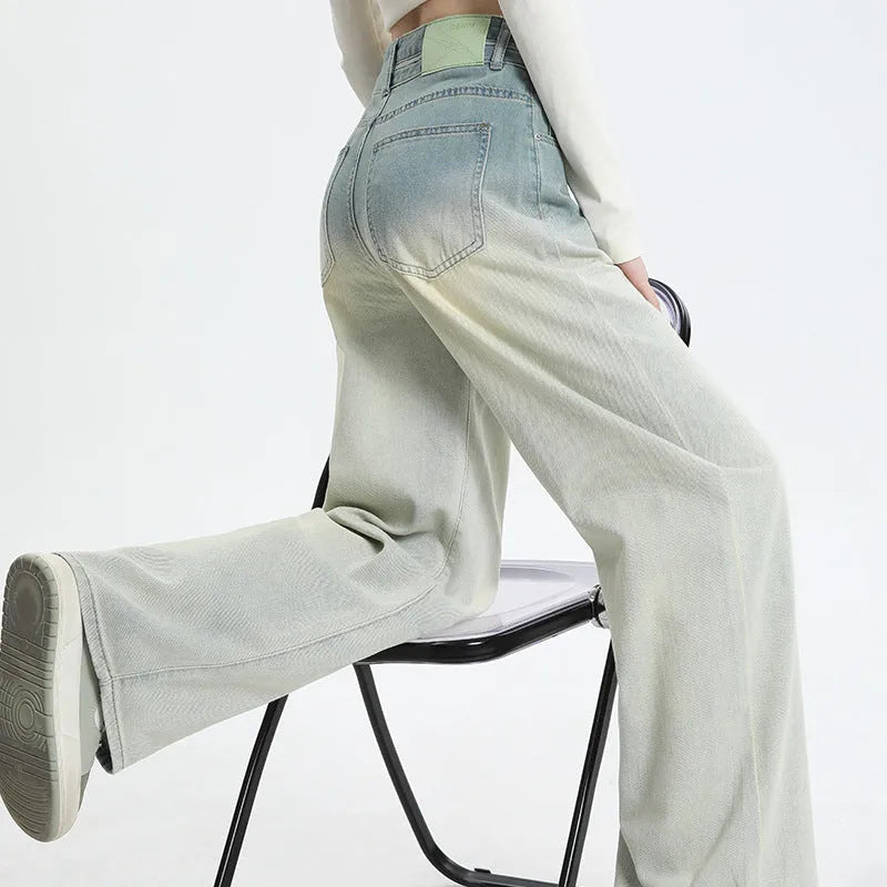 A pair of women's gradient blue wide-leg denim trousers on a neutral background.