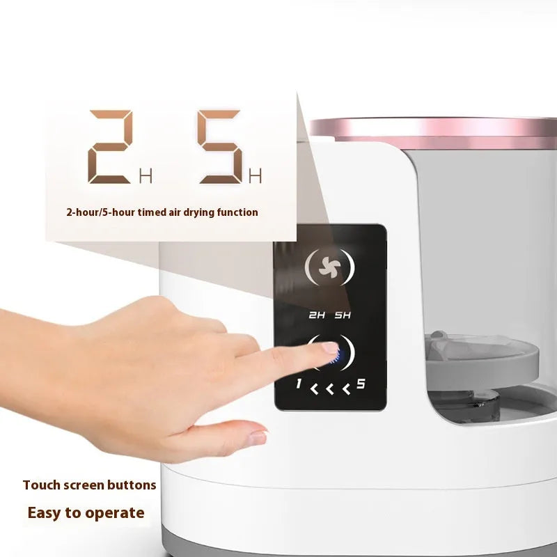 White rechargeable automatic makeup brush cleaner and dryer stand on a table
