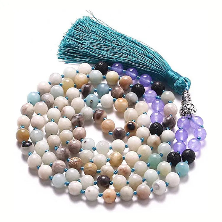 Long blue gemstone tassel necklace with agate, lapis lazuli, and turquoise beads on a geometric pendant.