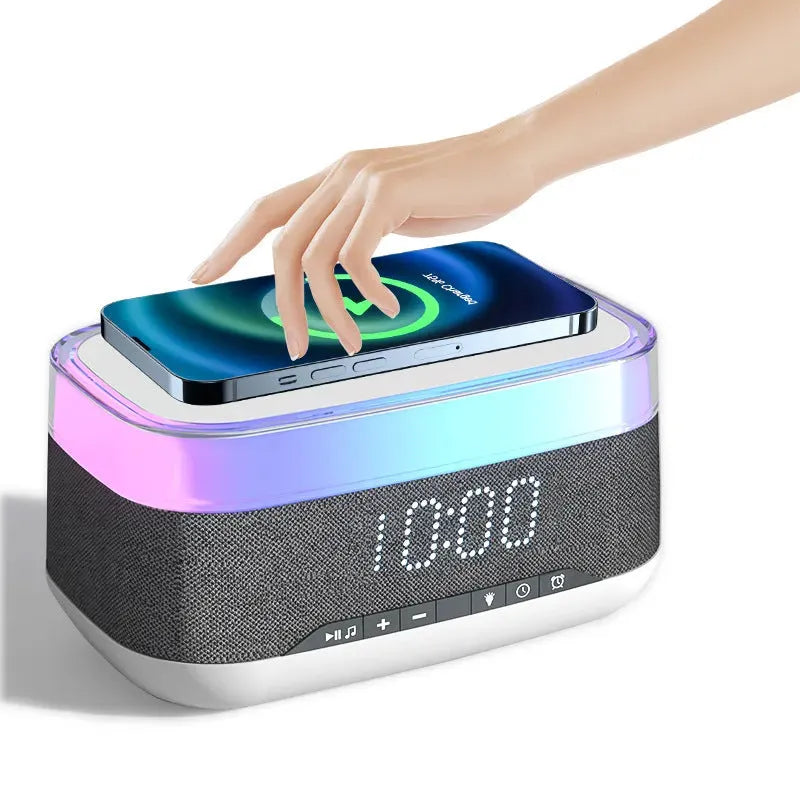 White alarm clock with wireless charging surface and Bluetooth speaker functionality for bedside use