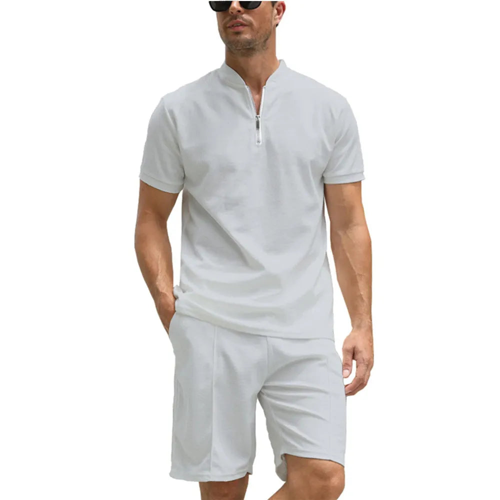 Men's solid colour polo shirt and matching trousers two-piece set in textured fabric.
