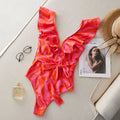 Women's printed one-piece swimsuit with ruffles on both shoulders and mesh stitching on the deep V-neck.