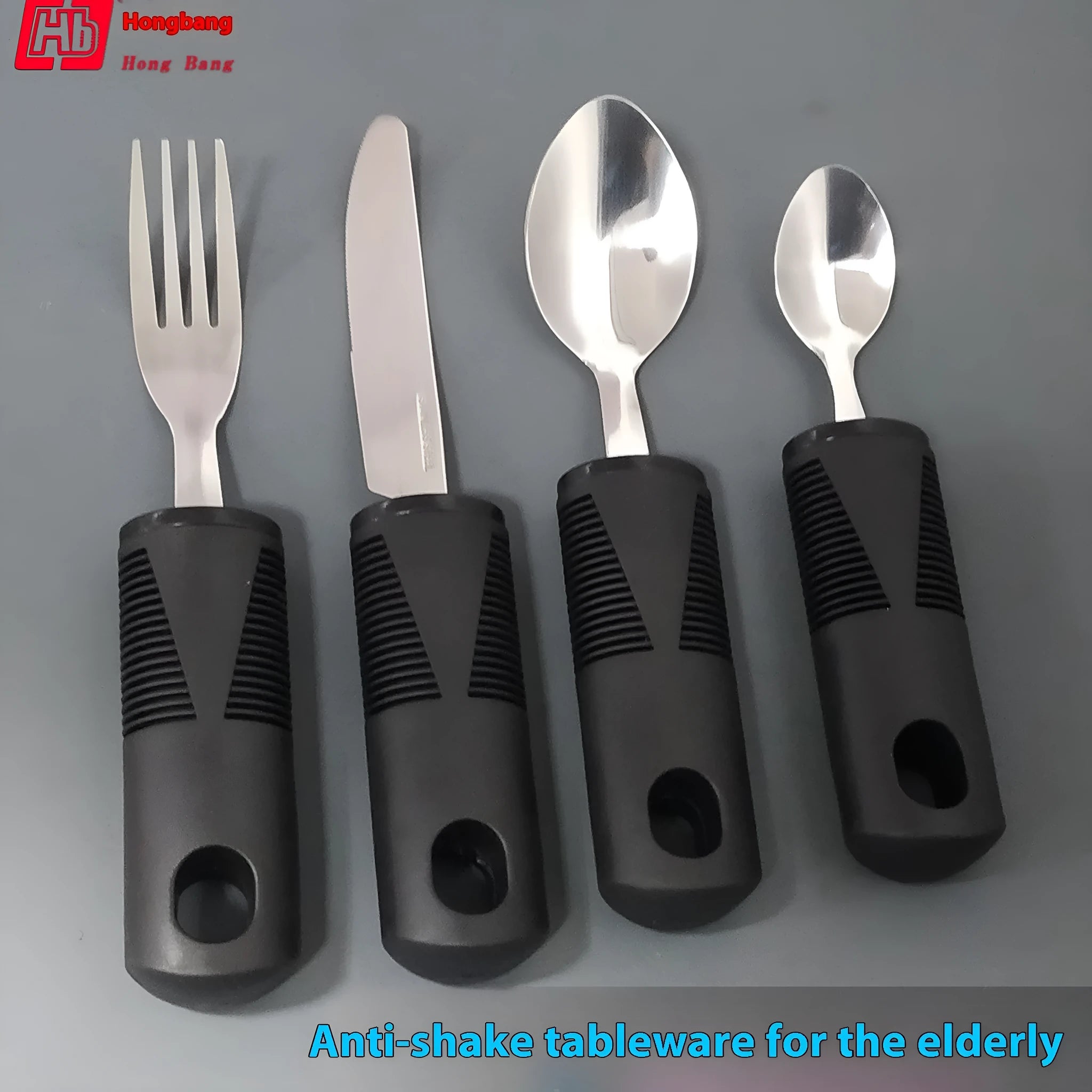Stainless steel adaptive cutlery set with black rubber handles, showing spoon and fork.