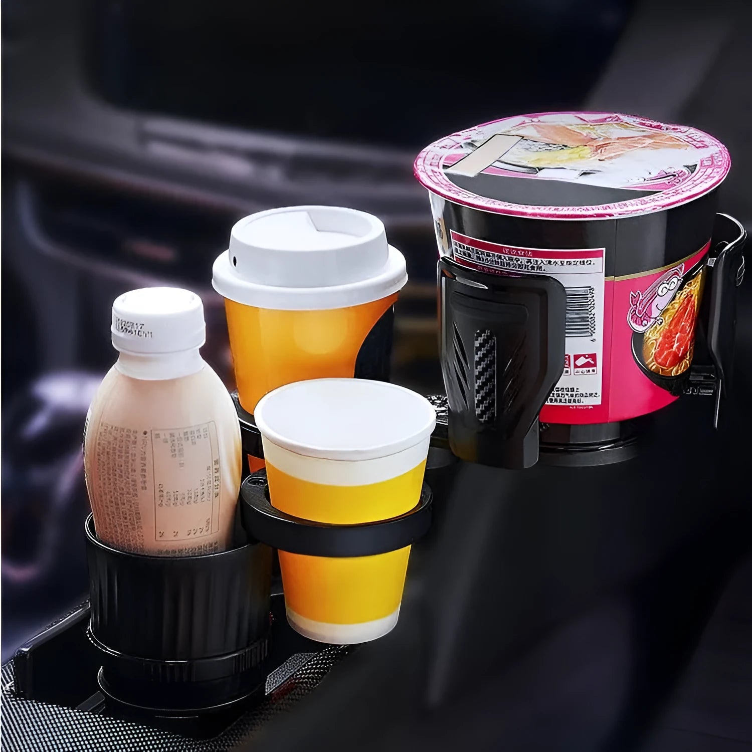 Carbon fibre black adjustable car cup holder with retractable base on a car centre console.