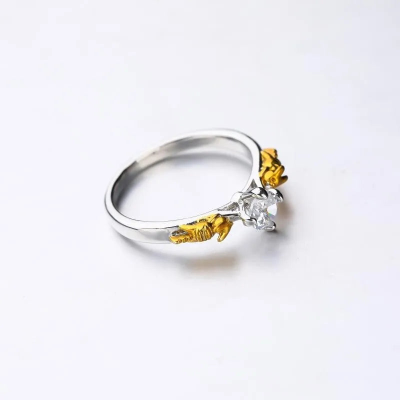 Copper crown-shaped crystal ring in a black gold tone on a neutral background.