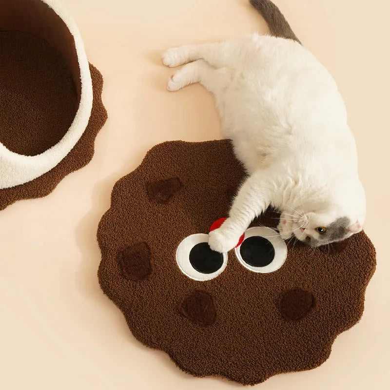 Khaki coloured enclosed cat nest shaped like a sandwich cookie with a circular entry hole.