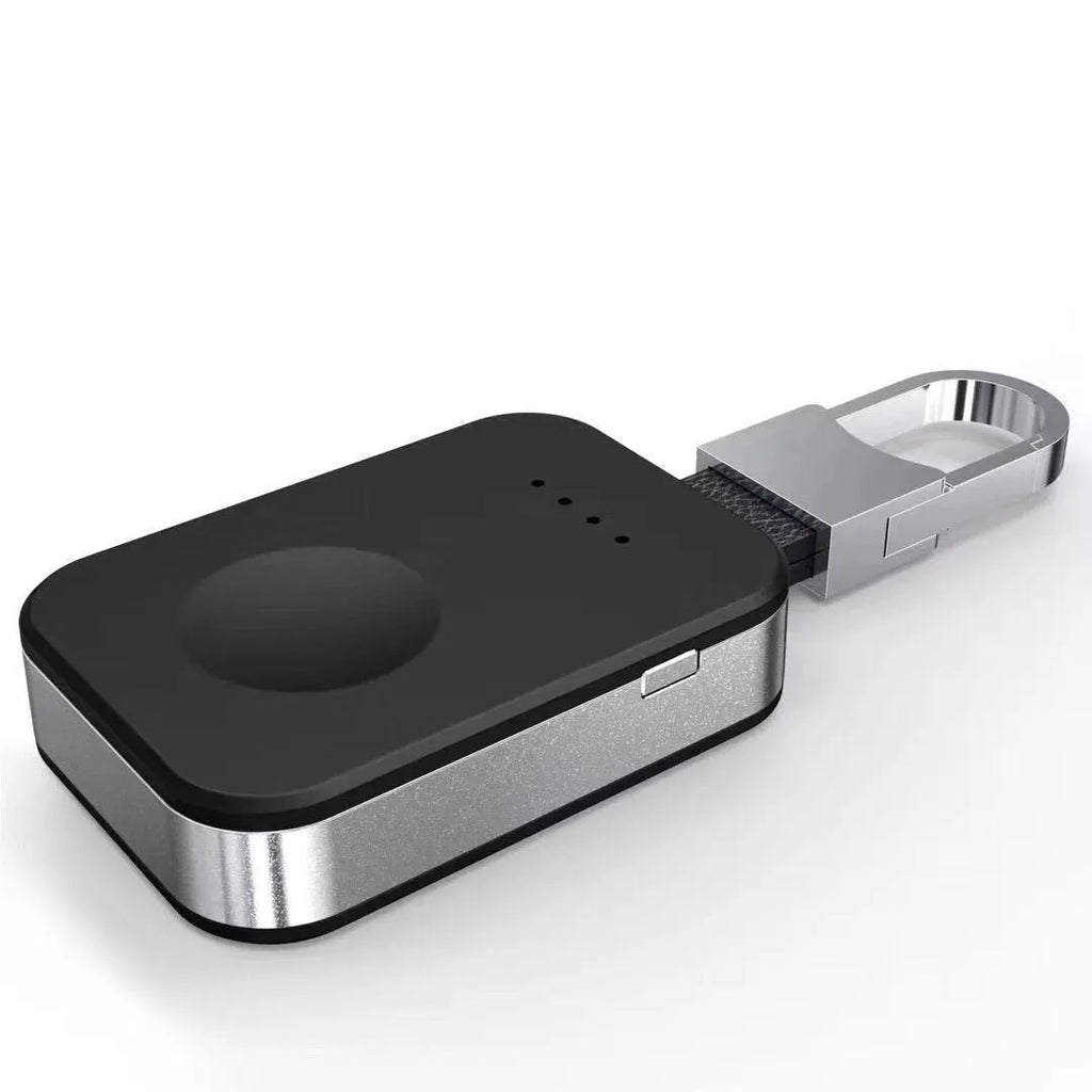 Black Apple Watch wireless charging power bank on a keychain, showing compact size.