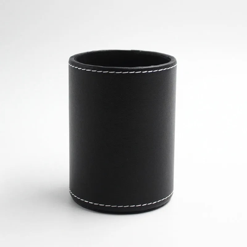 Small round black leather pen holder container showing cylindrical shape and compact dimensions