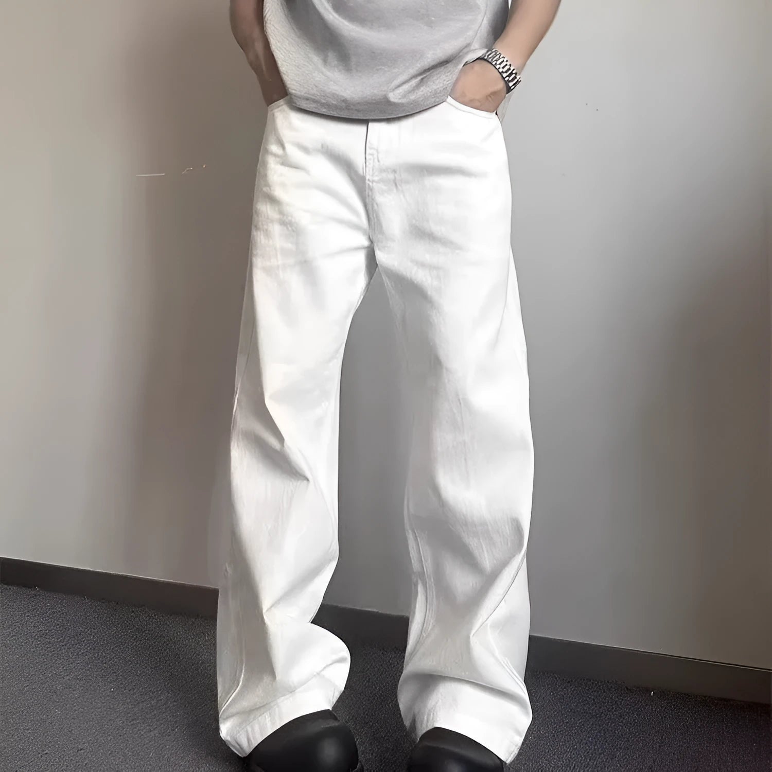 Men's straight leg white denim jeans with a mid waist and wide leg opening.