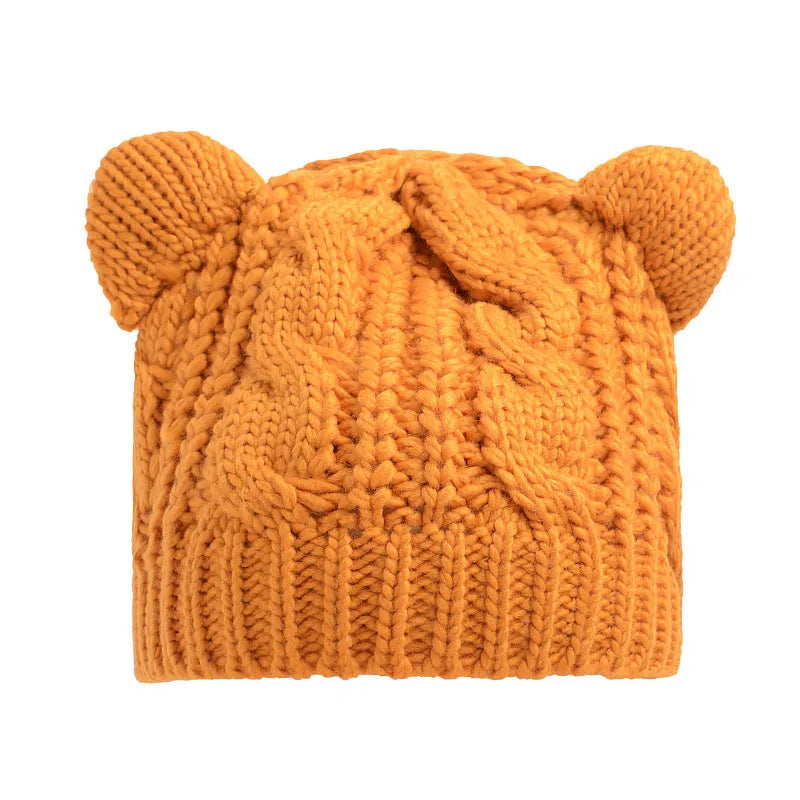 Handmade knitted winter beanie with 3D cat ears in red, shown on a model.