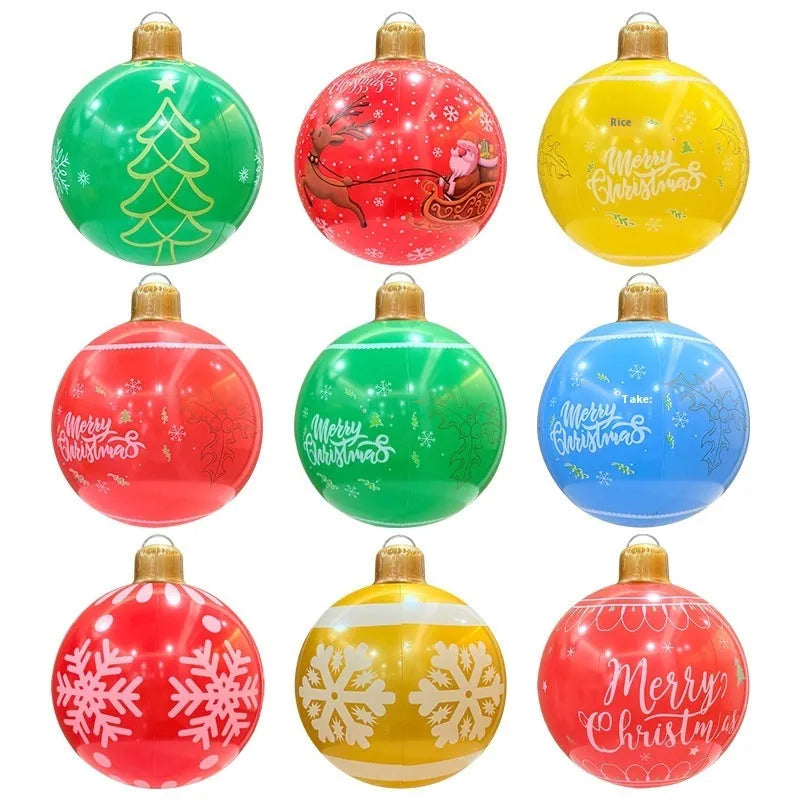 Large red inflatable Christmas ball with snowflake design in garden setting with flashing LED lights