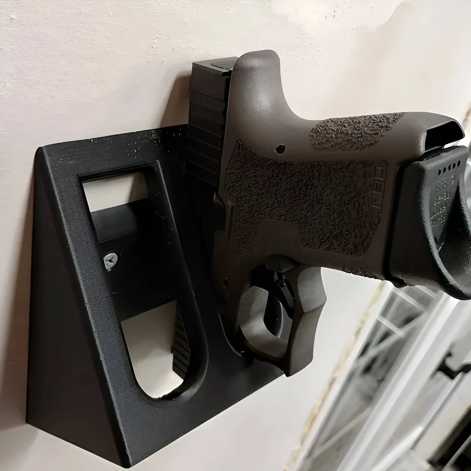 Black plastic pistol display stand for replica and collectable firearms.
