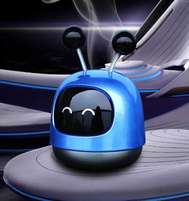 Robot-shaped car vent air freshener ornament in blue, grey or red with gel fragrance.