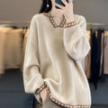 Women's camel V-neck long sleeve viscose sweater laid flat.