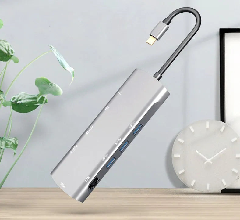 Grey aluminium USB-C docking station with HDMI, VGA, and USB ports.