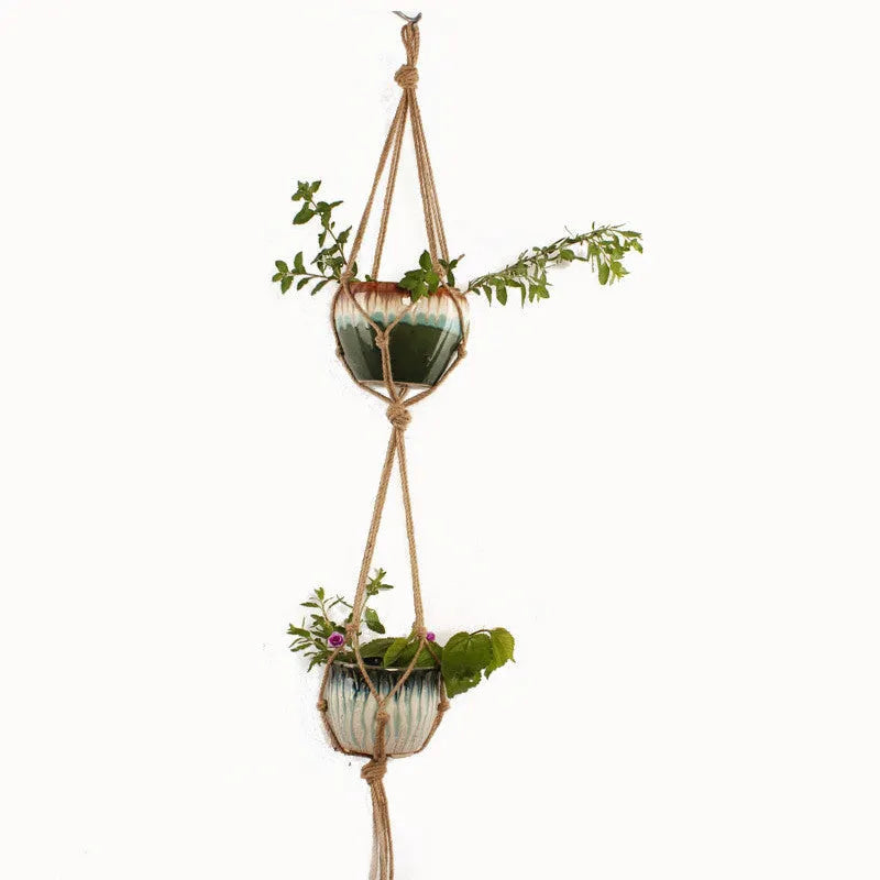 Woven cotton rope plant holder in a rustic style for hanging or tabletop use.