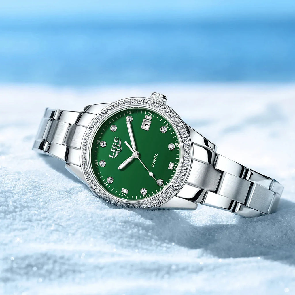 Silver stainless steel ladies watch with diamond-encrusted bezel and round blue dial.