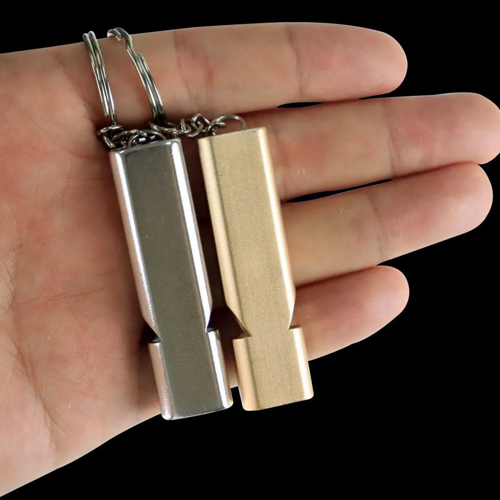 Silver or gold coloured aluminium alloy double hole outdoor survival whistle.