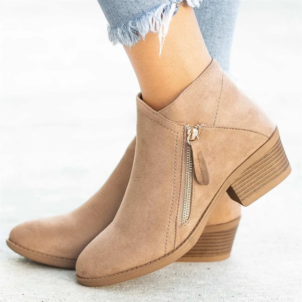 Women's suede ankle boots with a chunky heel and side zip fastening in beige colour.