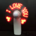 White handheld mini fan with blue and red LED lights spelling 'I love you' on a clear display.