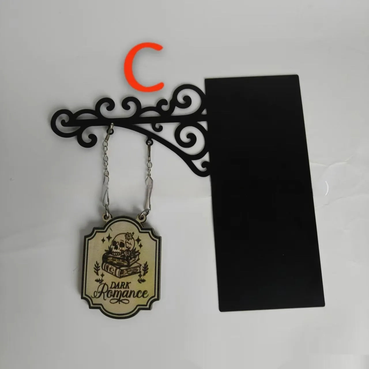 Decorative book nook divider shaped like a medieval tavern sign for shelf organisation