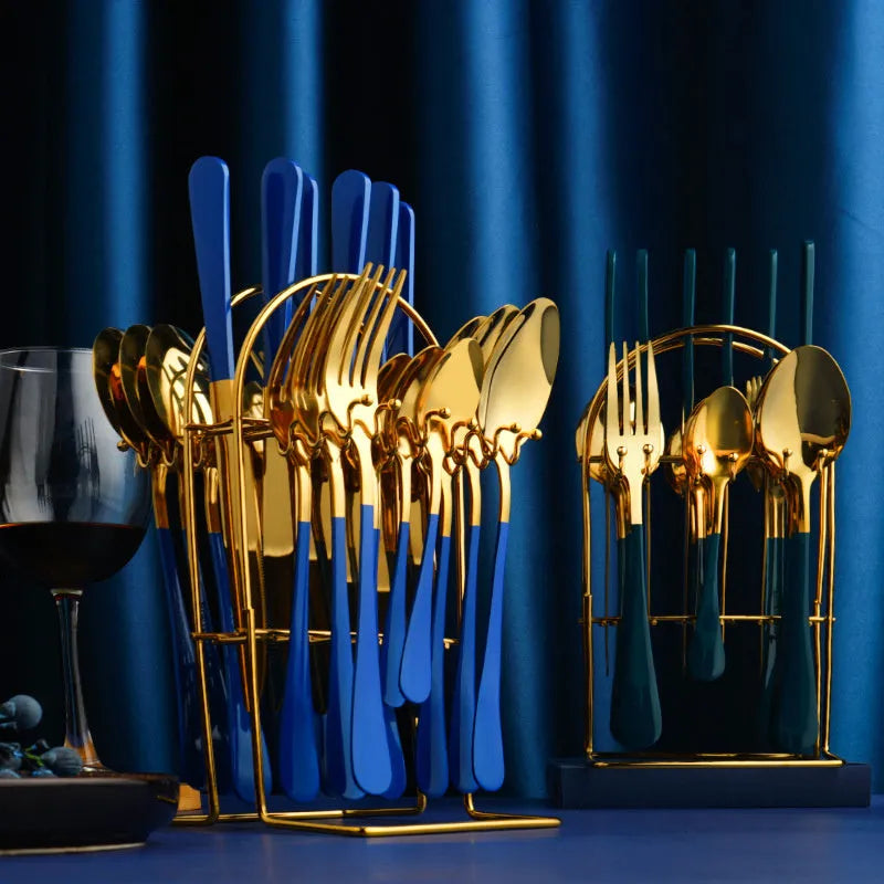 Gold stainless steel knife fork spoon cutlery set with storage rack on a table.