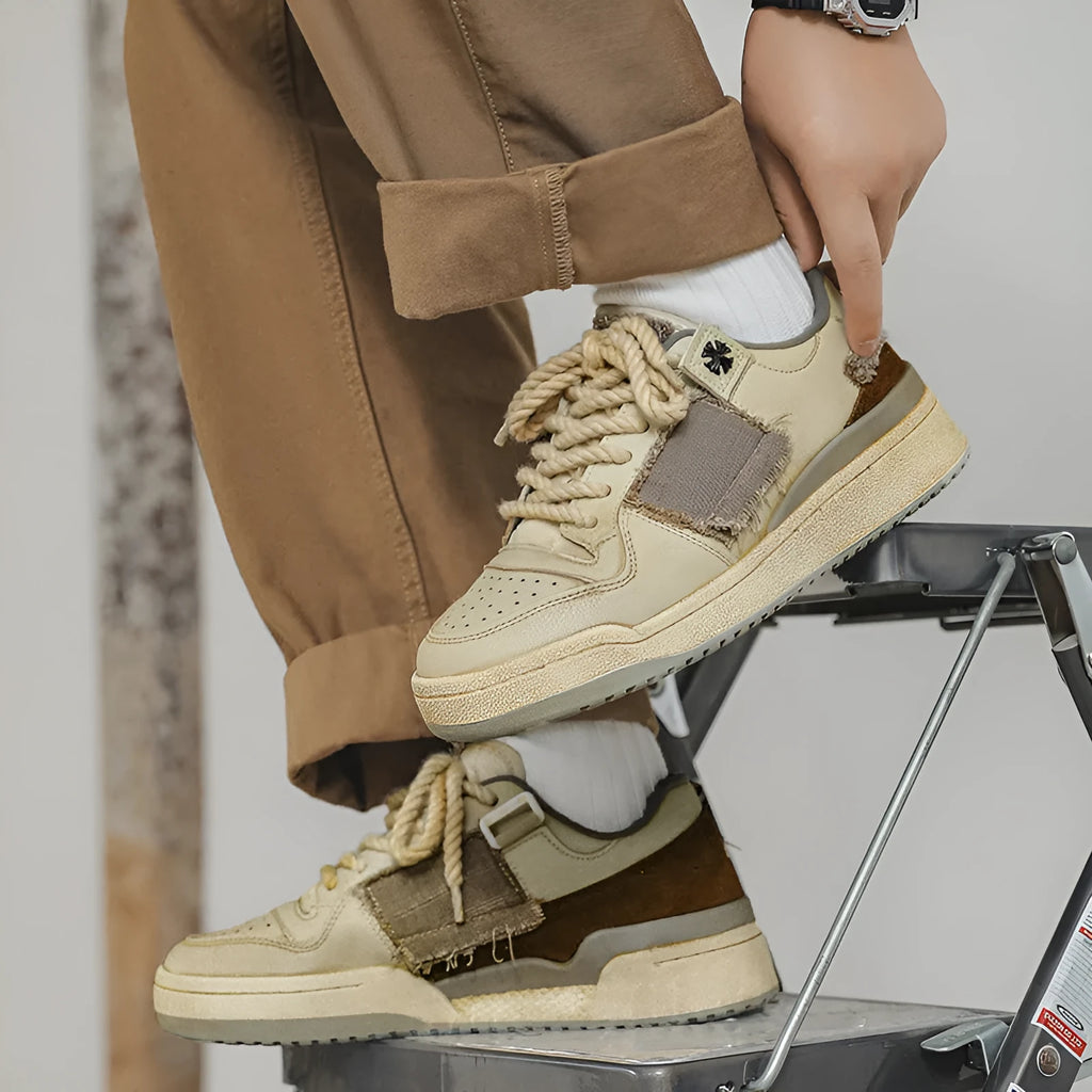 Beige low-top vintage skateboard shoes with round toe and rubber sole on a white background