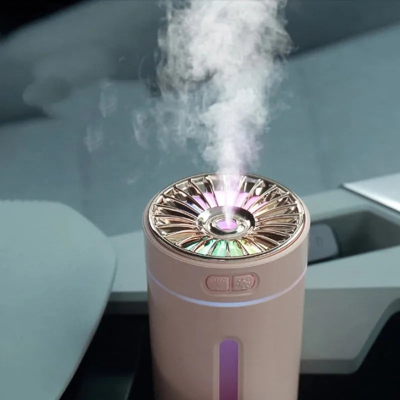 Black portable USB humidifier with colourful lights on a car cup holder.