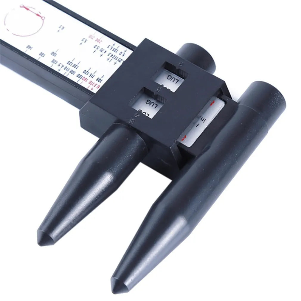 Plastic electronic digital caliper hole distance measuring tool with digital display on a work surface.