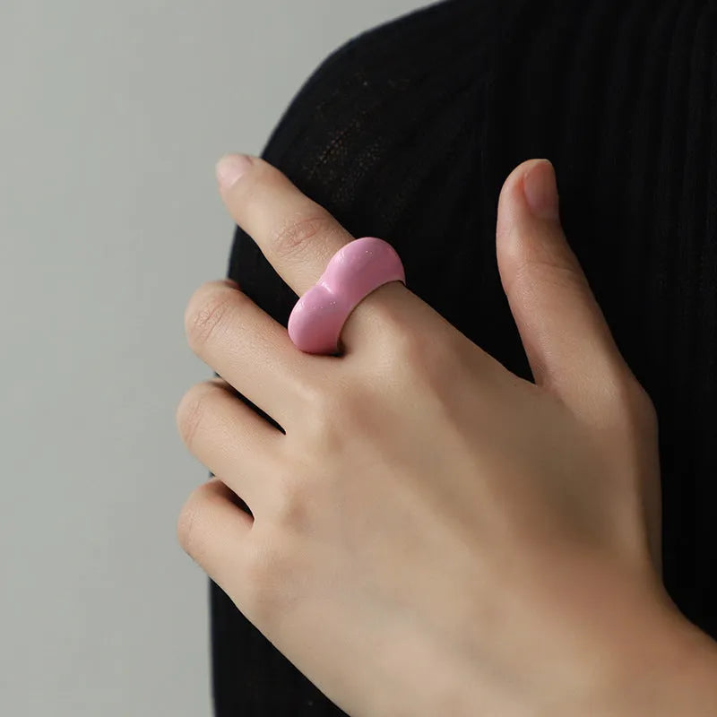 Heart-shaped zinc alloy ring with colourful three-dimensional enamel details on a neutral background.
