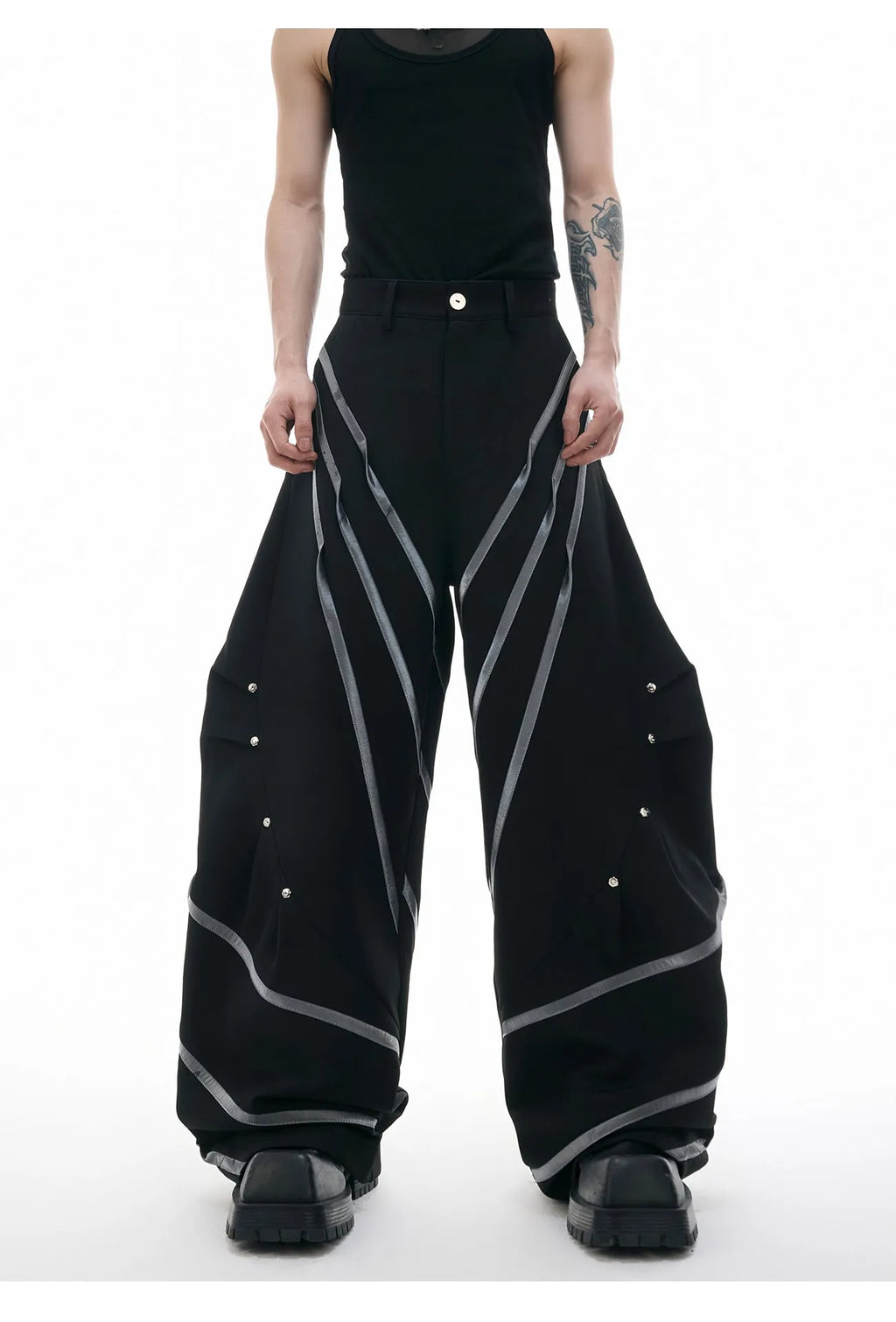Men's black polyester trousers with metal striped rivet pleats and three-dimensional tailoring.