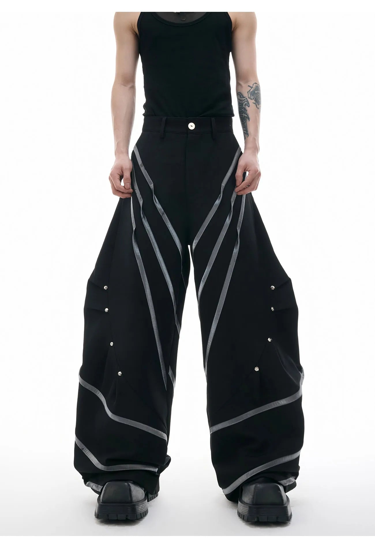 Men's black polyester trousers with metal striped rivet pleats and three-dimensional tailoring.