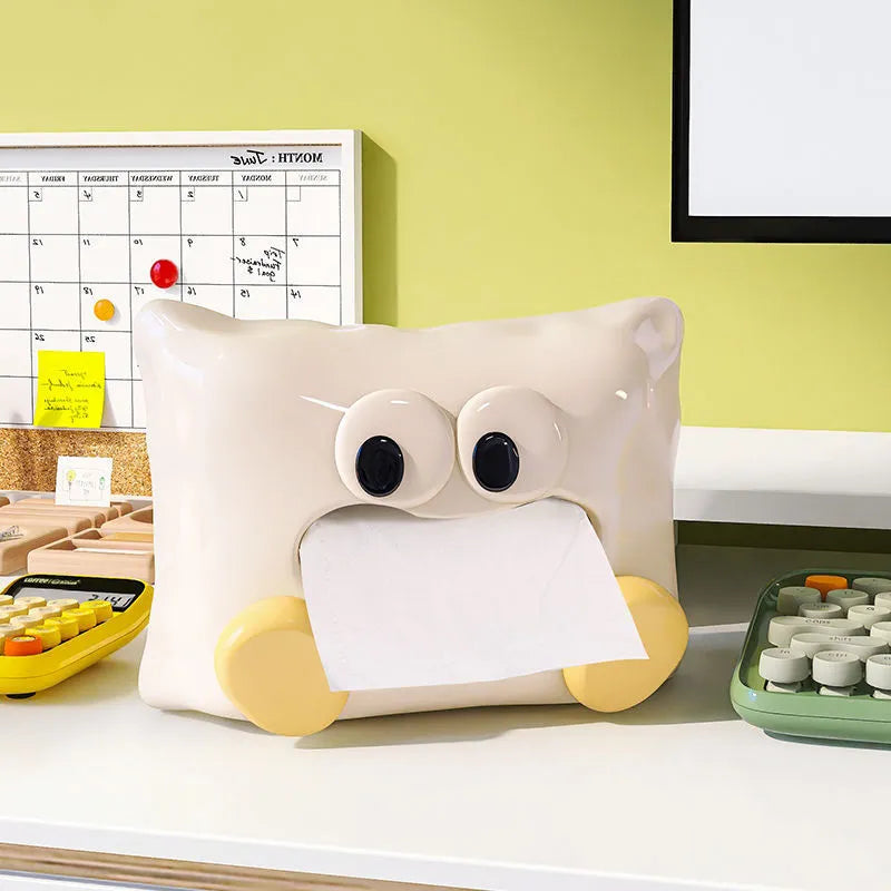 White ceramic tissue box holder on a wooden table.