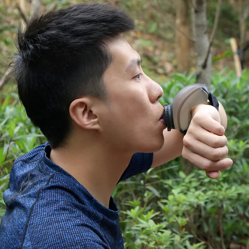 Orange wrist-mounted water bottle with Velcro strap shown on wrist during running activity