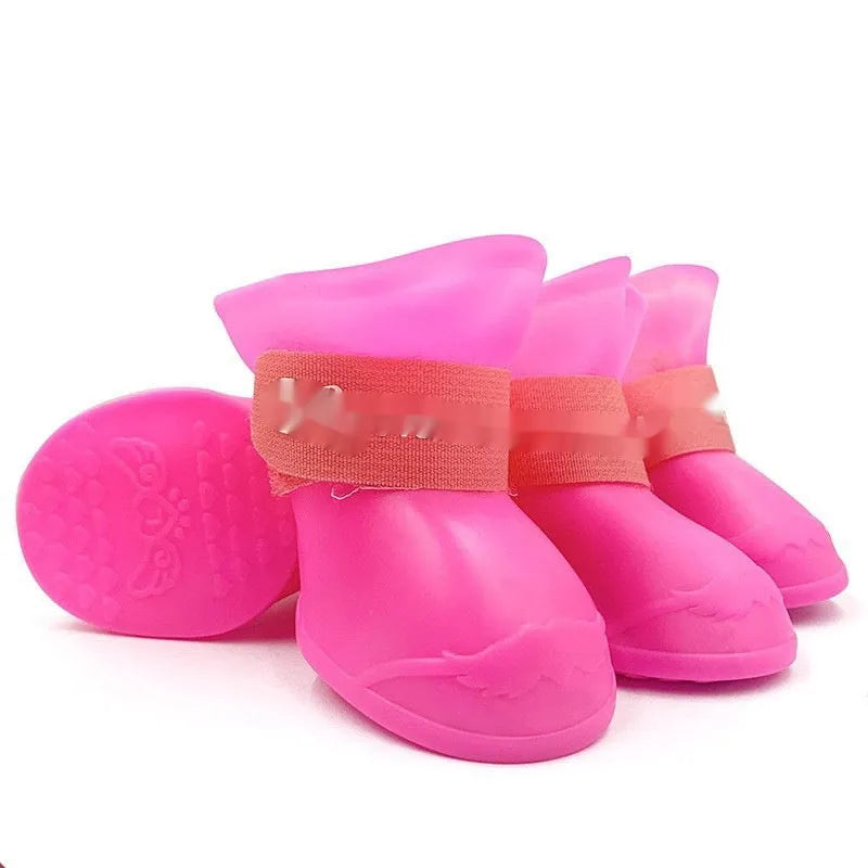Set of four anti-slip pet rain shoes in various colours with rubber soles for waterproof dog paw protection.