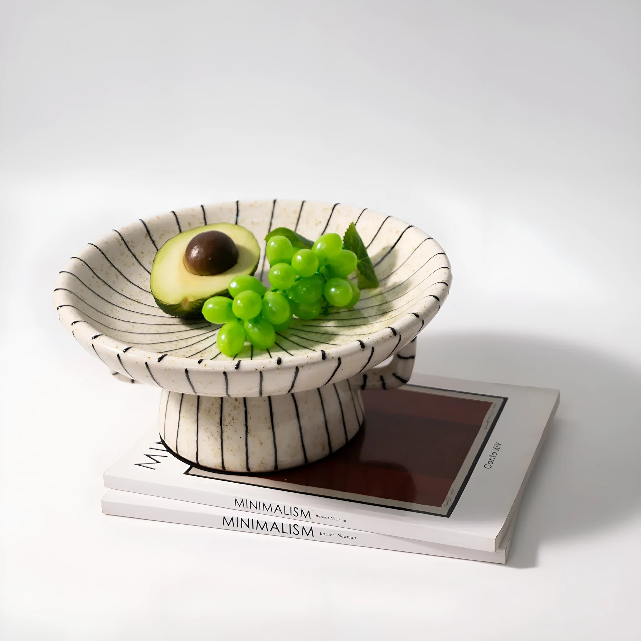 Black and white striped retro style synthetic resin fruit plate on a wooden surface.