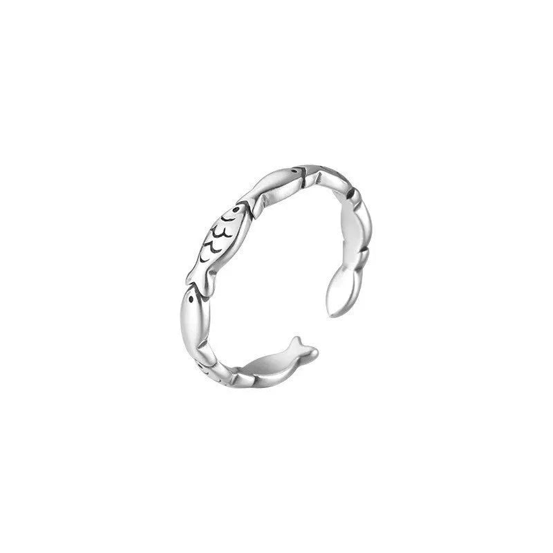 Women's sterling silver adjustable fish ring with carp motif on finger.